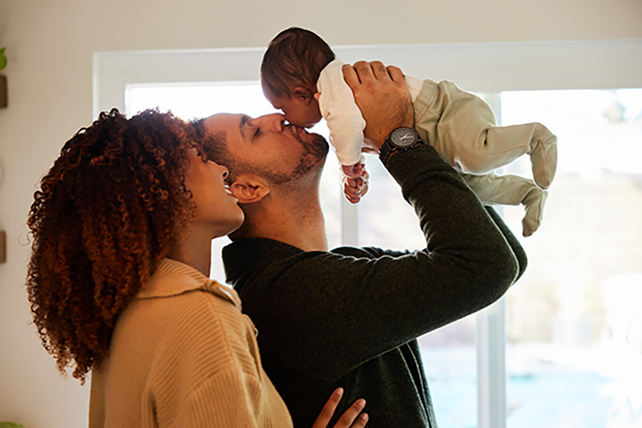 New parents admiring infant